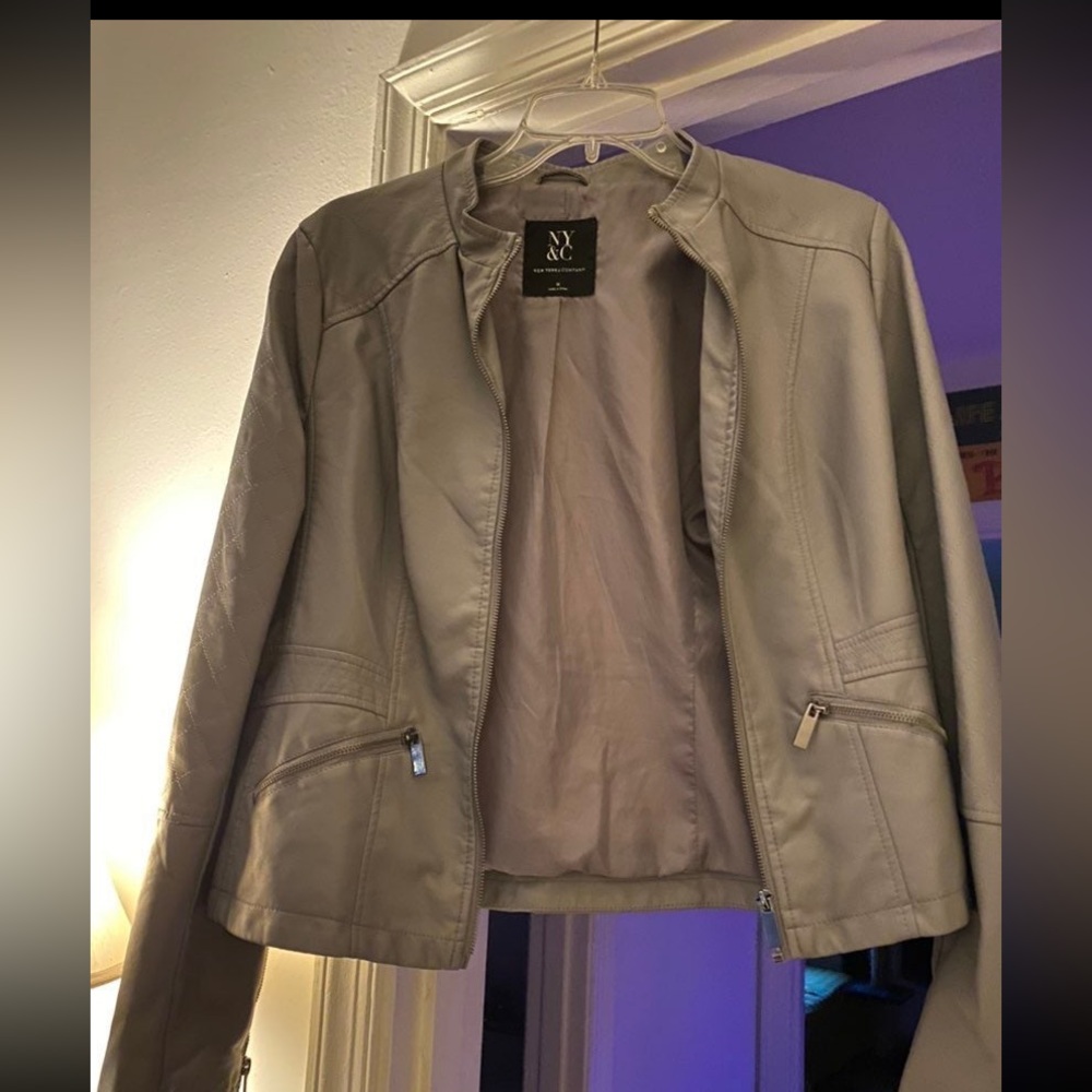 Grey PVC leather look jacket. Quilted detailing & zippers down sleeves.